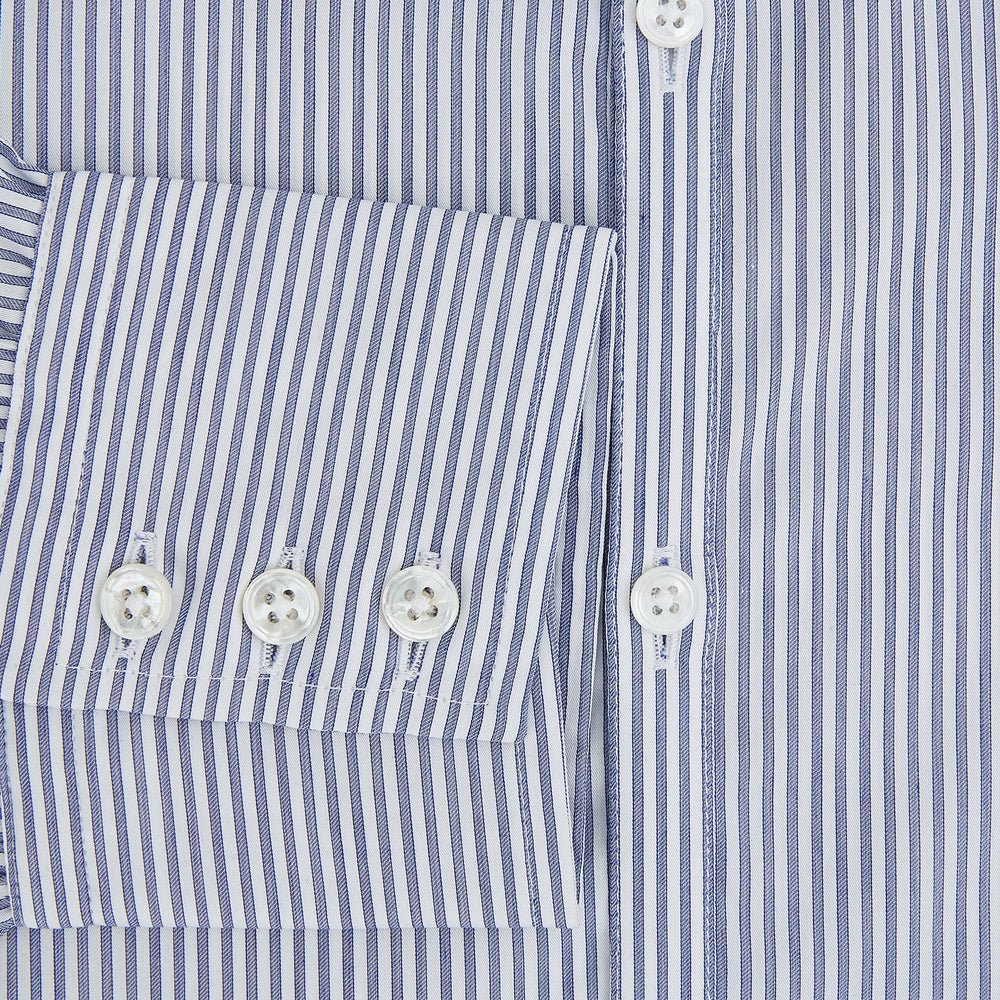 The Turnbull & Asser Navy and White Stripe Westminster Shirt features thin vertical stripes, a Turnbull collar, long sleeves, and classic British craftsmanship, shown flat on a white background.