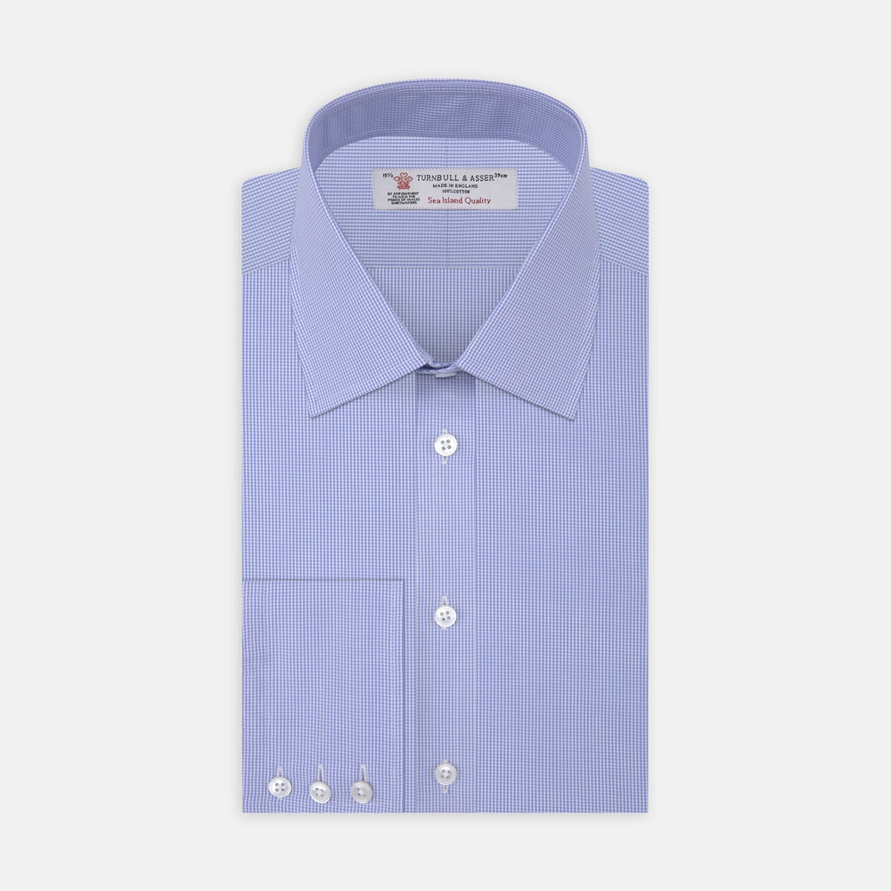 A neatly folded Turnbull & Asser Blue Fine Check Sea Island Quality Cotton Shirt features a T&A collar, 3-button cuffs, subtle micro-check pattern, and white buttons down the front.