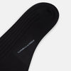 View 3 of product A single Turnbull & Asser Black Wool Mid-Length Sock is displayed on a plain white background, angled to reveal its full length from toe to cuff.