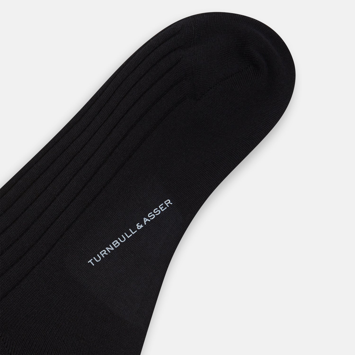View 3 of product A single Turnbull & Asser Black Wool Mid-Length Sock is displayed on a plain white background, angled to reveal its full length from toe to cuff.