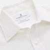 View 3 of product The White Cotton Weekend Fit Langston Shirt by Turnbull & Asser, with a Derby collar, long sleeves, and two button-flap chest pockets, is shown laid flat on a white background.