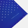 View 2 of product The Turnbull & Asser Royal Blue and White Spotted Silk Scarf features evenly spaced small white dots, fringed edges, and the brand’s name printed near the ends.