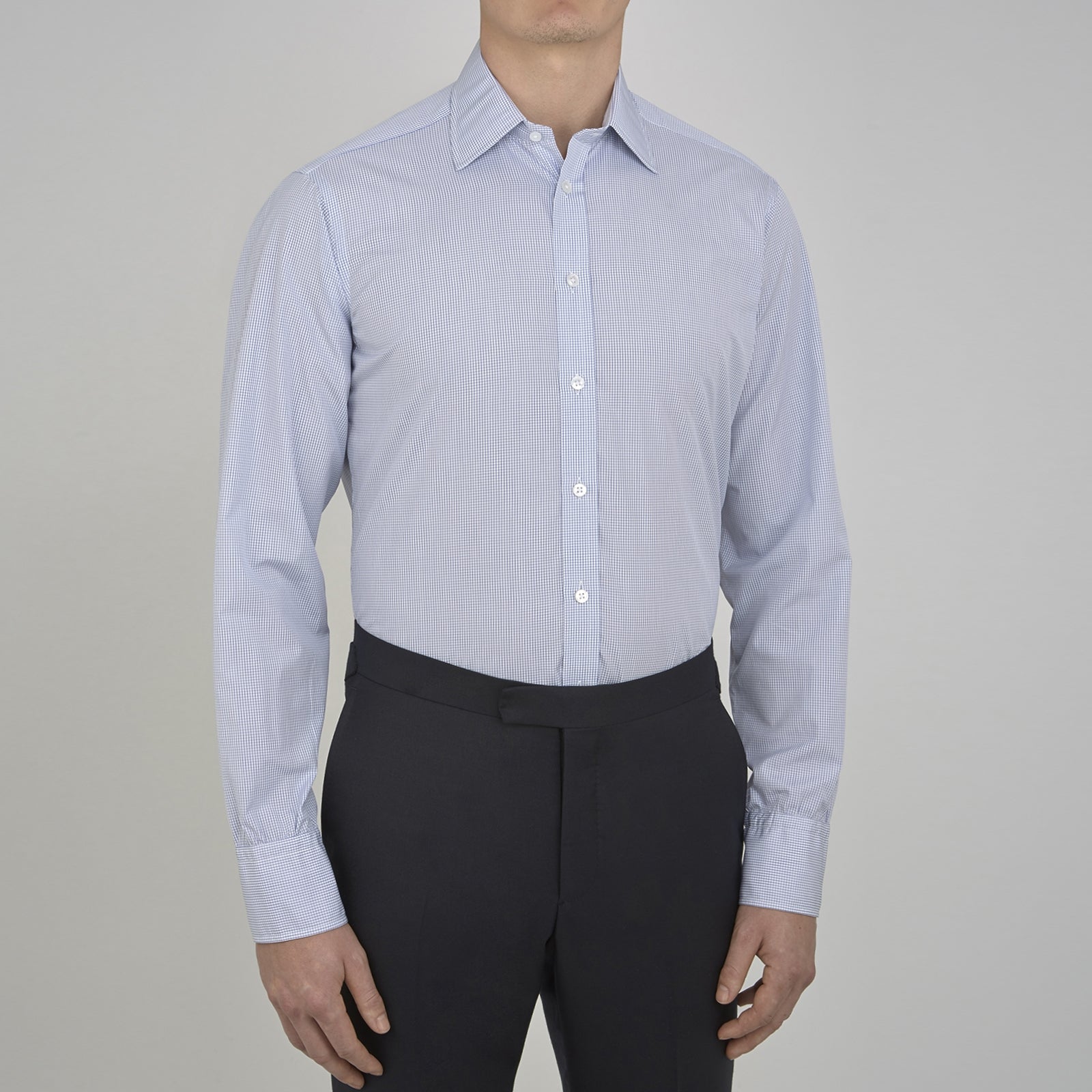 View 4 of product A neatly folded Turnbull & Asser Blue Grid Check Shirt features a T&A collar, 3-button cuffs, white buttons, and subtle British style. The blue and white check cotton design displays the brand label inside the collar.