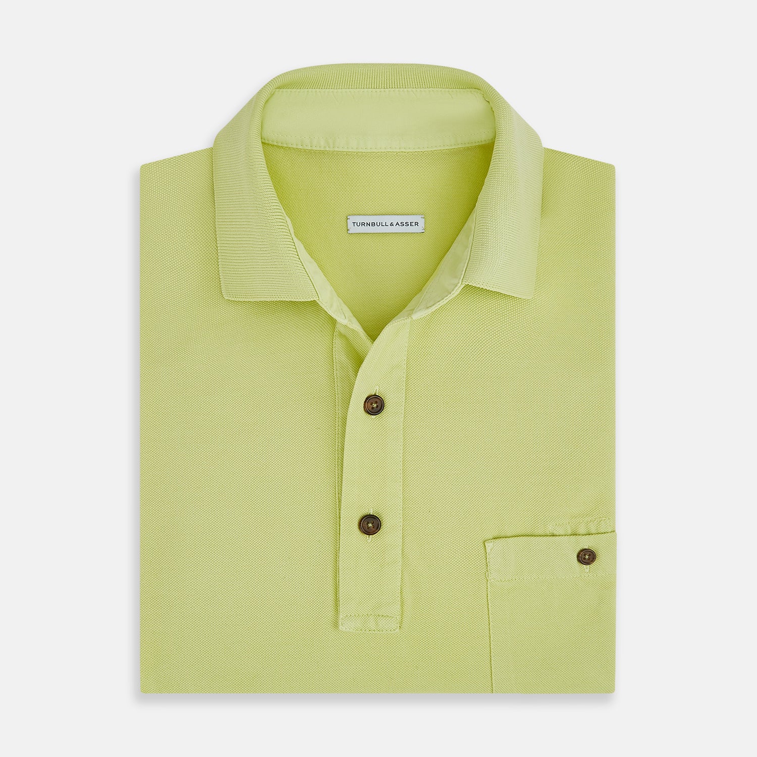 View 4 of product The Turnbull & Asser Lime Green Polo Shirt features a cotton jersey build, short sleeves, a collar, three brown buttons on the placket, and a chest pocket with a button. Shirt shown laid flat on a white background.