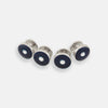 View 1 of product Four Turnbull & Asser Navy Gemstone Circle Dress Studs, each round with dark blue enamel borders and a central clear gemstone, are arranged diagonally on a plain white background.