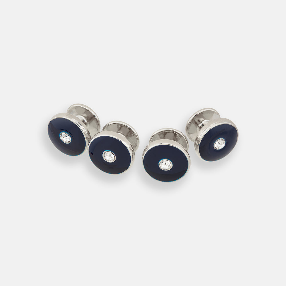 Four Turnbull & Asser Navy Gemstone Circle Dress Studs, each round with dark blue enamel borders and a central clear gemstone, are arranged diagonally on a plain white background.