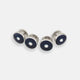 Four Turnbull & Asser Navy Gemstone Circle Dress Studs, each round with dark blue enamel borders and a central clear gemstone, are arranged diagonally on a plain white background.