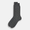View 2 of product The Grey Patterned Mid-Length Socks by Turnbull & Asser are crafted from soft Egyptian cotton, with a ribbed cuff and small white diamond shapes on a grey background.