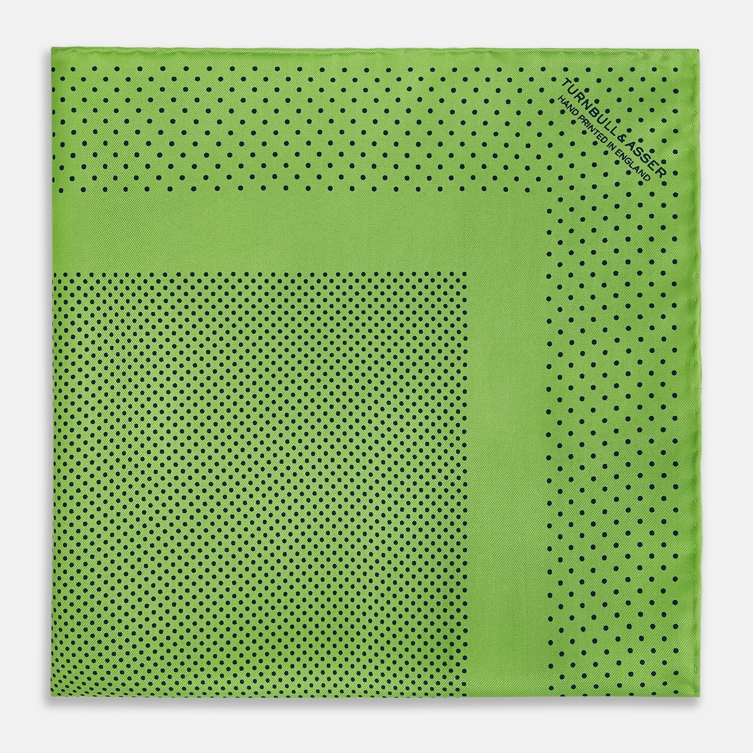 View 3 of product The Turnbull & Asser Kelly Green Dot Silk Pocket Square features small black polka dots and is shown neatly folded to showcase both its front and inner sides.