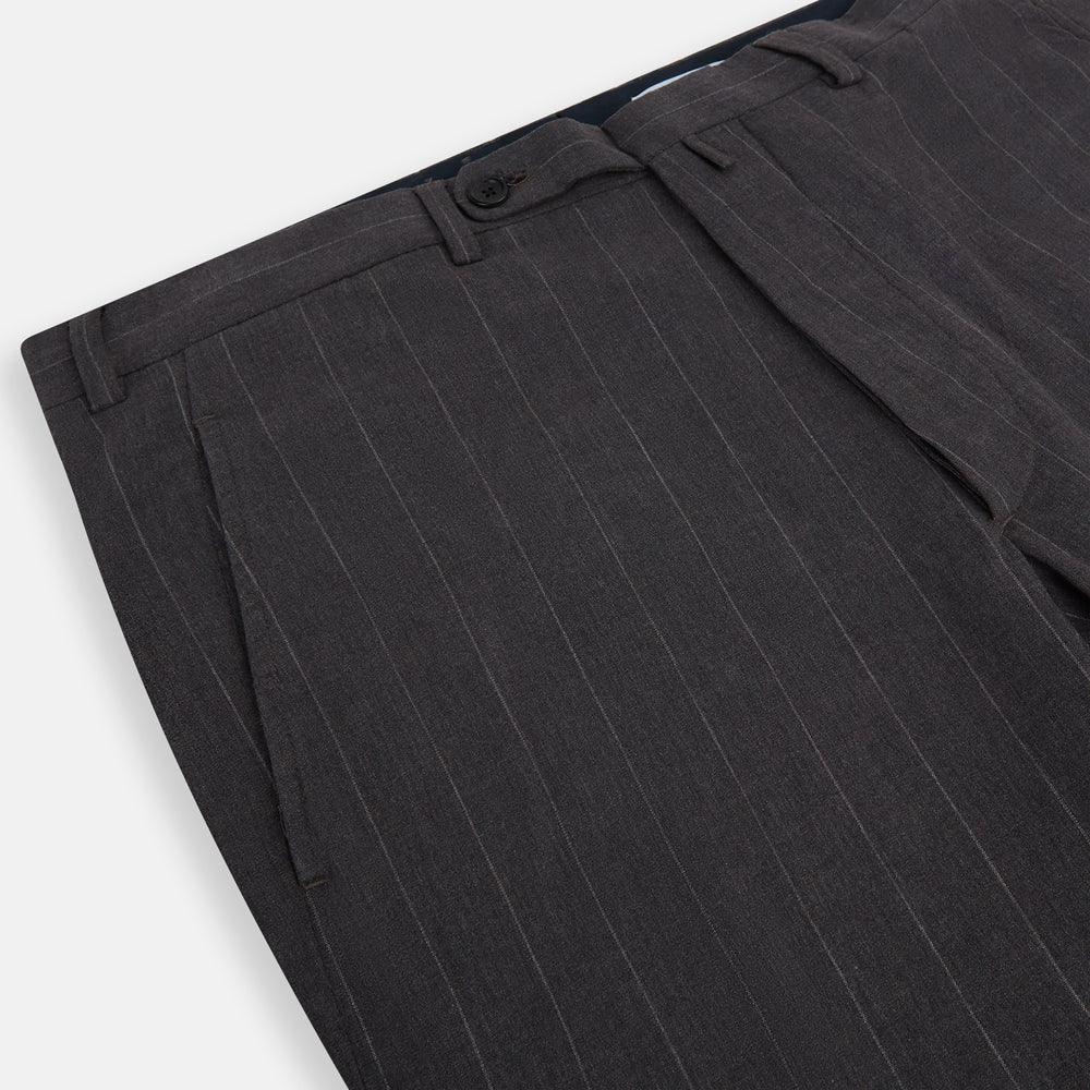 Turnbull & Asser’s Dark Chocolate Striped Edmund trousers feature straight-cut legs, a relaxed fit, button closure, and belt loops. These cotton trousers display subtle vertical stripes against a plain white background.