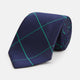 The Turnbull & Asser Green and Navy Window Pane Silk Tie features a subtle ribbed texture with a diagonal green grid pattern, inspired by archival designs—a stylish choice for modern office attire.