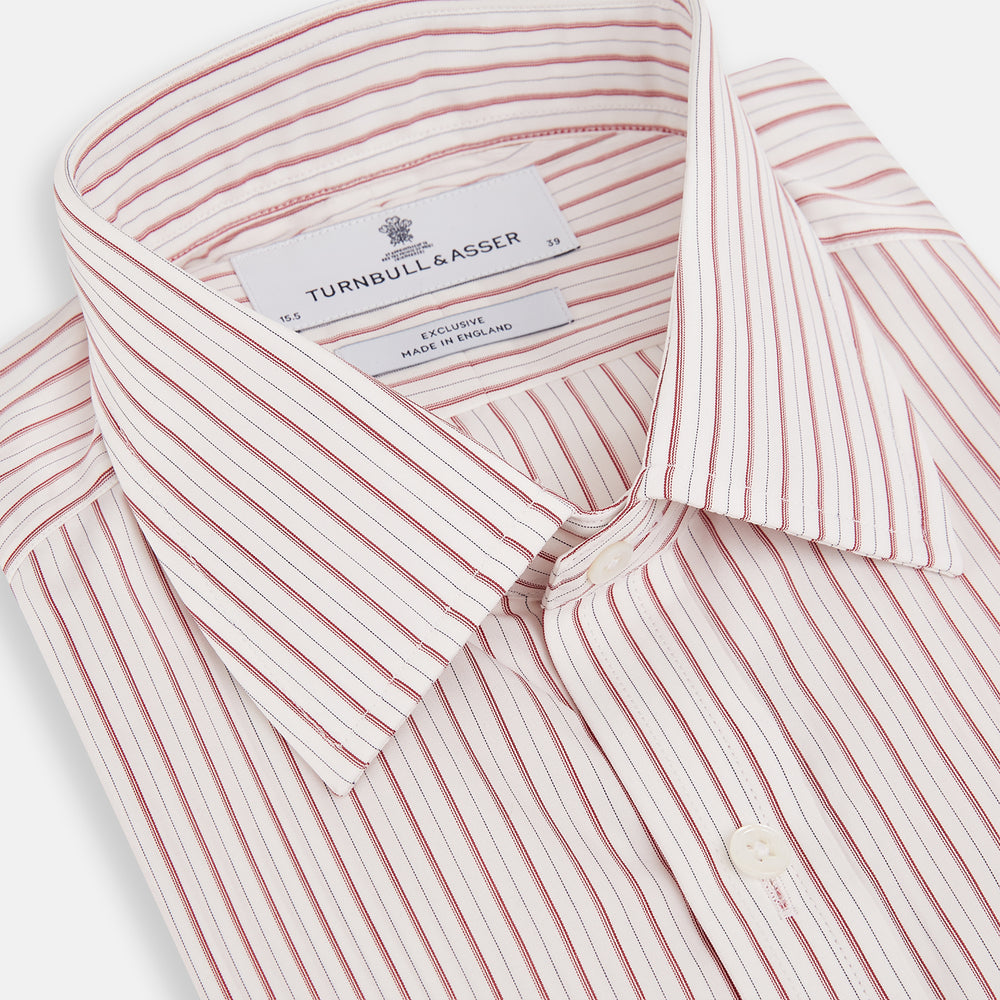 The Red Multi Ticking Stripe Mayfair Shirt by Turnbull & Asser features thin red and blue vertical stripes on white, a T&A collar, long sleeves, and button-up design.