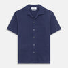 View 3 of product The Navy Silk Holiday Fit Phillips Shirt by Turnbull & Asser features short sleeves, a revere collar, and three front patch pockets, shown laid flat on a white background.