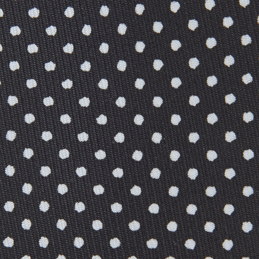 The Turnbull & Asser Black and White Spot Printed Silk Tie, shown neatly rolled on a plain white background, is an essential accessory to elevate any smart attire.