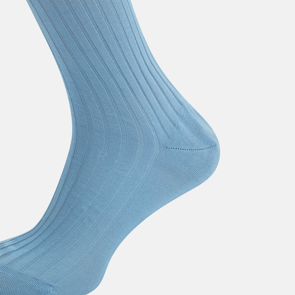 A single Turnbull & Asser Pale Blue Long Sock, featuring a ribbed texture and crafted from mercerised Egyptian cotton, is displayed upright on a plain white background.
