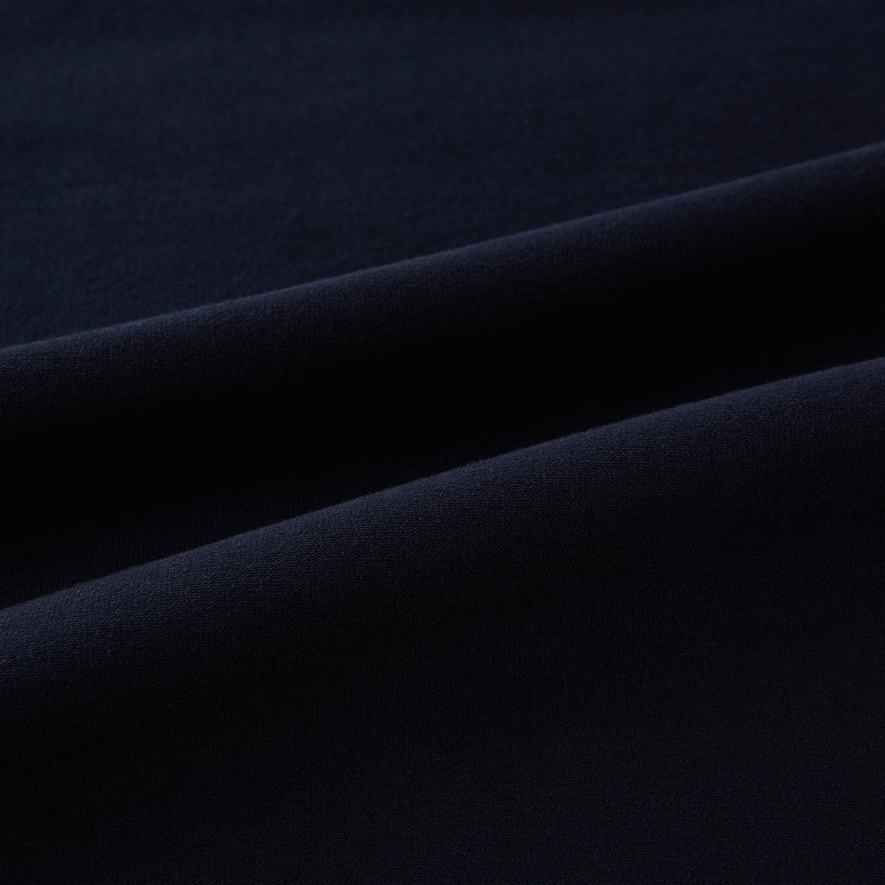 A navy short-sleeve pyjama shirt by Turnbull & Asser is laid flat on a white background, displaying the front view. Its soft fabric ensures comfort with no visible logos, designs, or patterns on the shirt.