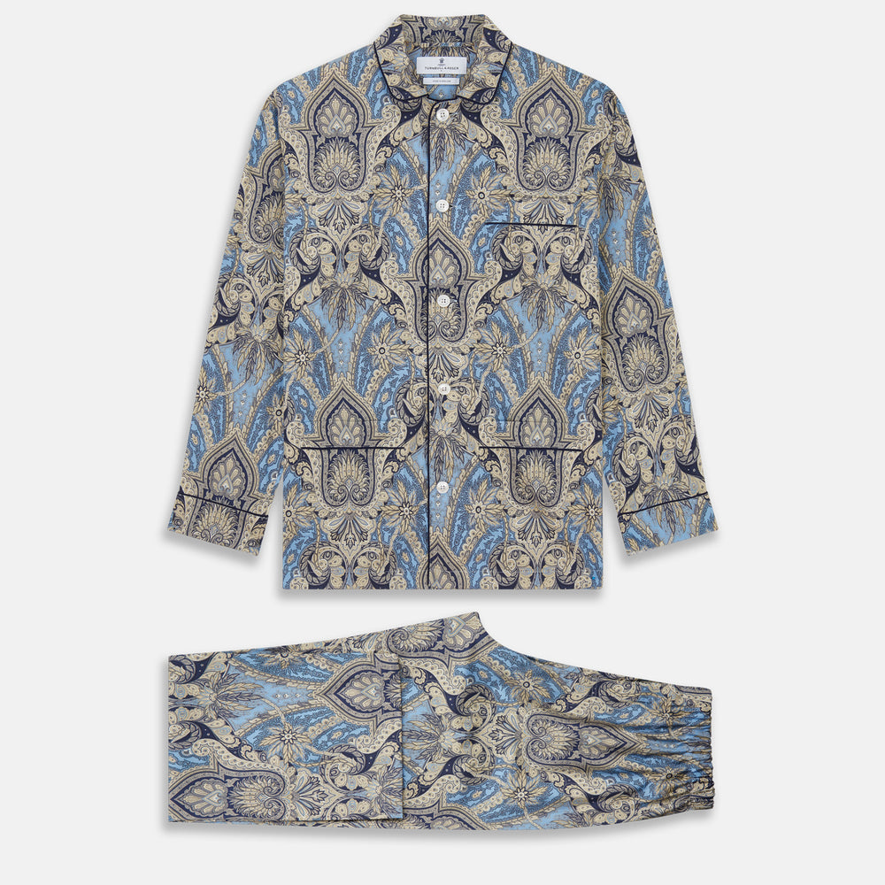 The Turnbull & Asser Pale Blue Baroque Silk-blend Hyde Pyjama Set features a long-sleeve button-up shirt and pants in a blue and beige paisley pattern, shown flat on a white background.