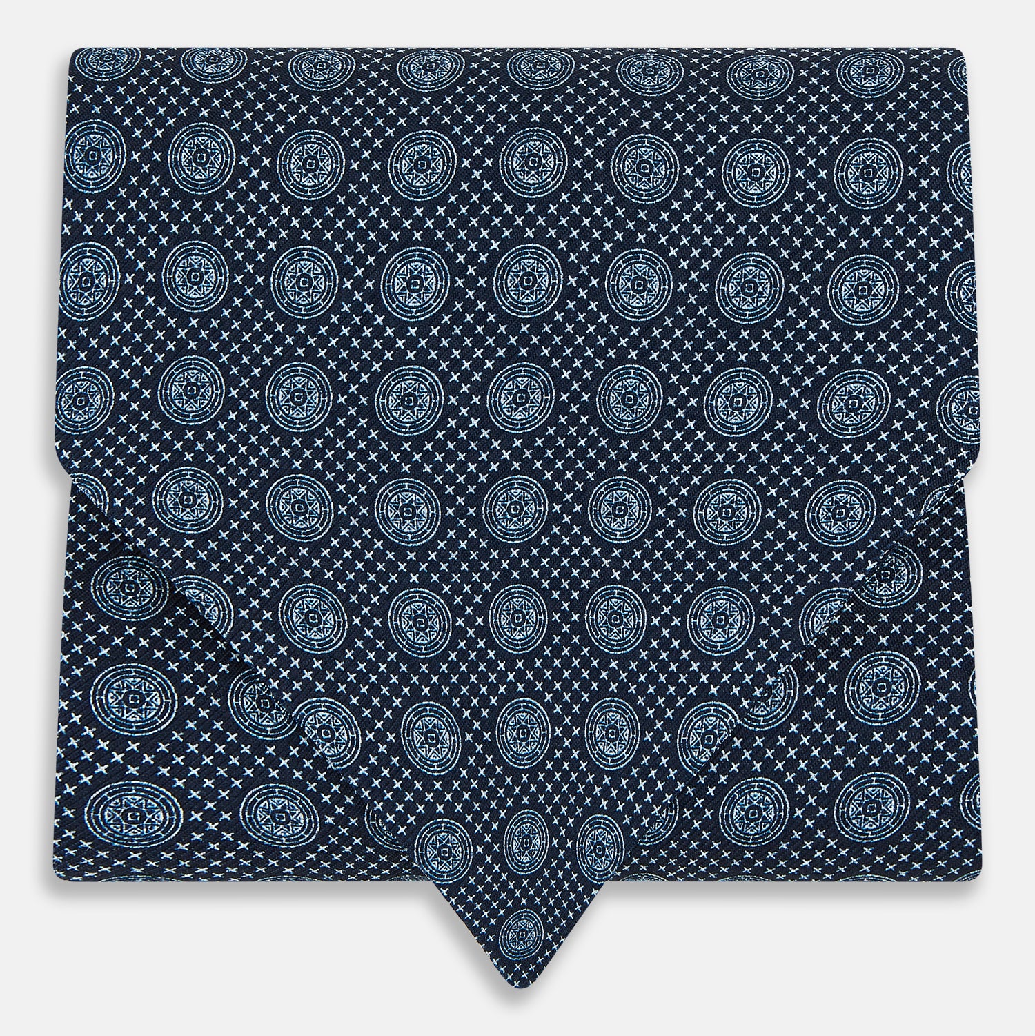 View 1 of product The Turnbull & Asser Navy Medallion Silk Cravat features a white geometric and circular pattern, its classic design and rich navy hue echoing refined British elegance.