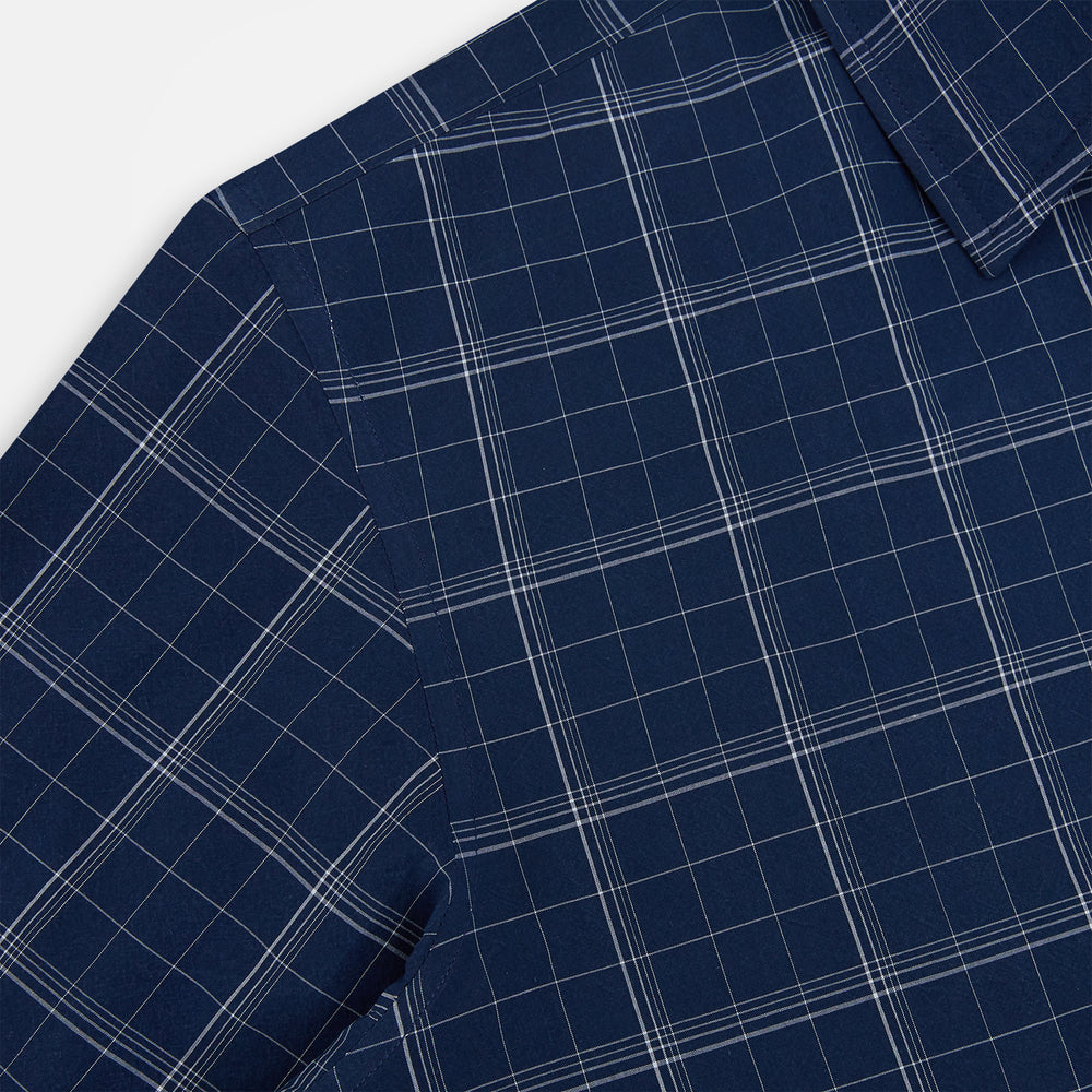 The Indigo and White Thin Plaid Check Windsor Shirt by Turnbull & Asser, a long-sleeve button-up with white buttons, is shown laid flat on a white background.