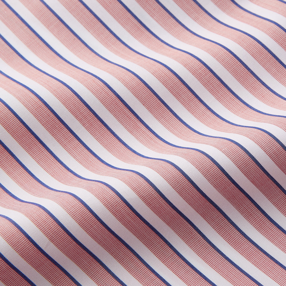 The Orange Multi Stripe Cotton Sussex Nightshirt by Turnbull & Asser features a classic collar, red and white vertical stripes, a chest pocket with blue trim, button-down front, and curved hem—a luxe take on the traditional nightshirt.