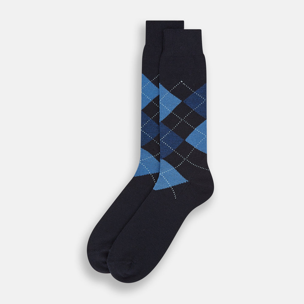 A single Turnbull & Asser Navy/Blue Wool Check Mid-Length Sock, featuring a blue and light blue check pattern, is displayed upright on a plain white background.