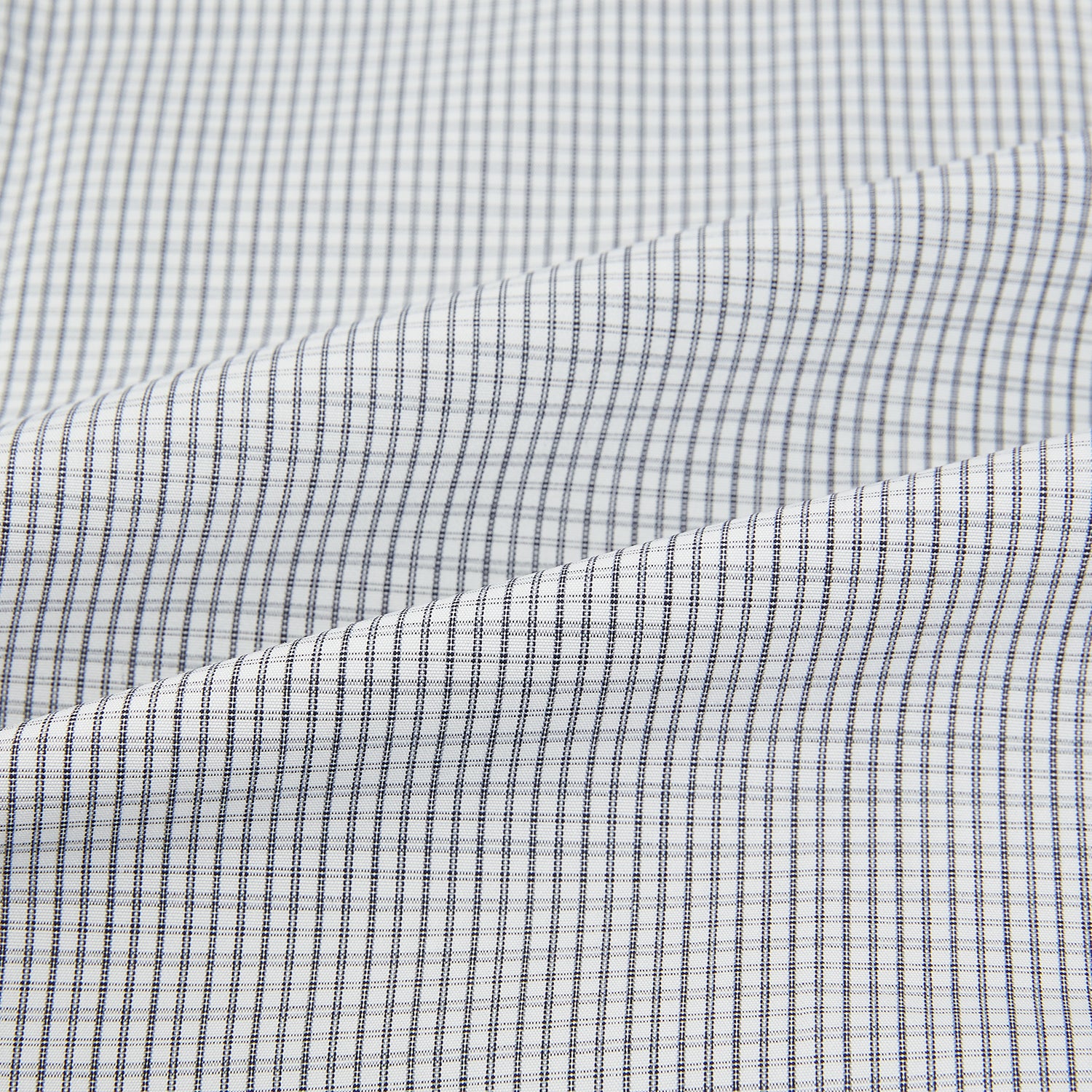 View 6 of product The Midnight Blue Micro Tattersall Check Mayfair Shirt by Turnbull & Asser, made from pure cotton with white buttons, a classic collar, and cuffed sleeves, is laid flat on a white background.
