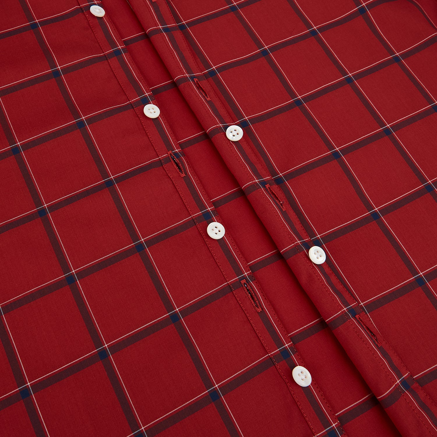 View 7 of product The Turnbull & Asser Dark Red Grid Check Windsor Shirt is a long-sleeved, button-up shirt with a dark red base and black and white grid pattern, displayed flat on a white background.