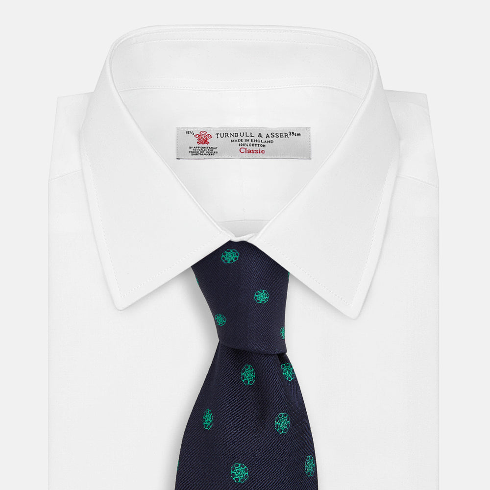 The Green flower and navy silk tie by Turnbull & Asser is perfect for adding a touch of color to any classic wardrobe.