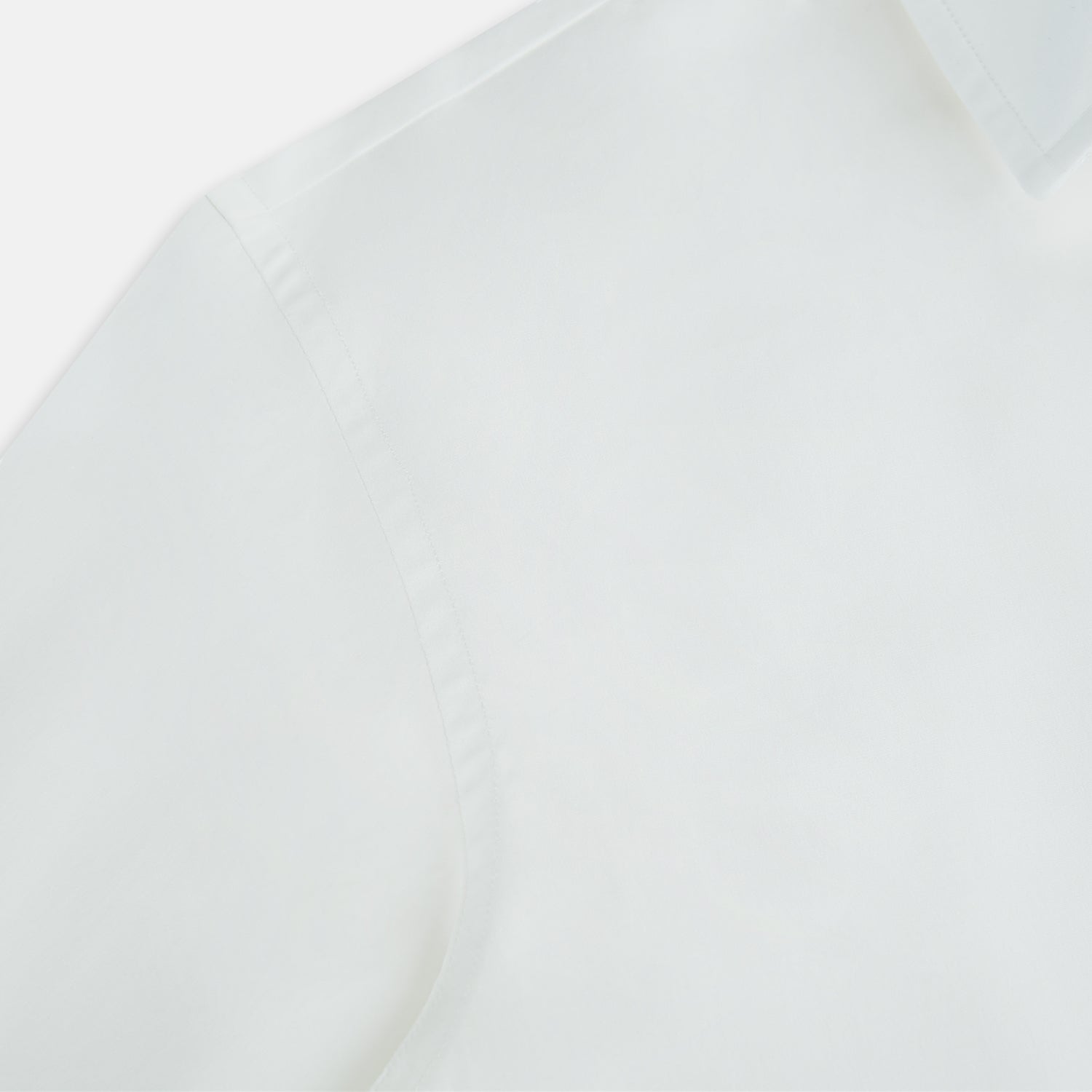 View 6 of product The Turnbull & Asser Plain White Windsor Shirt features a Turnbull open collar, 3-button cuffs, and relaxed fit—exemplifying British craftsmanship. Displayed on a white background.