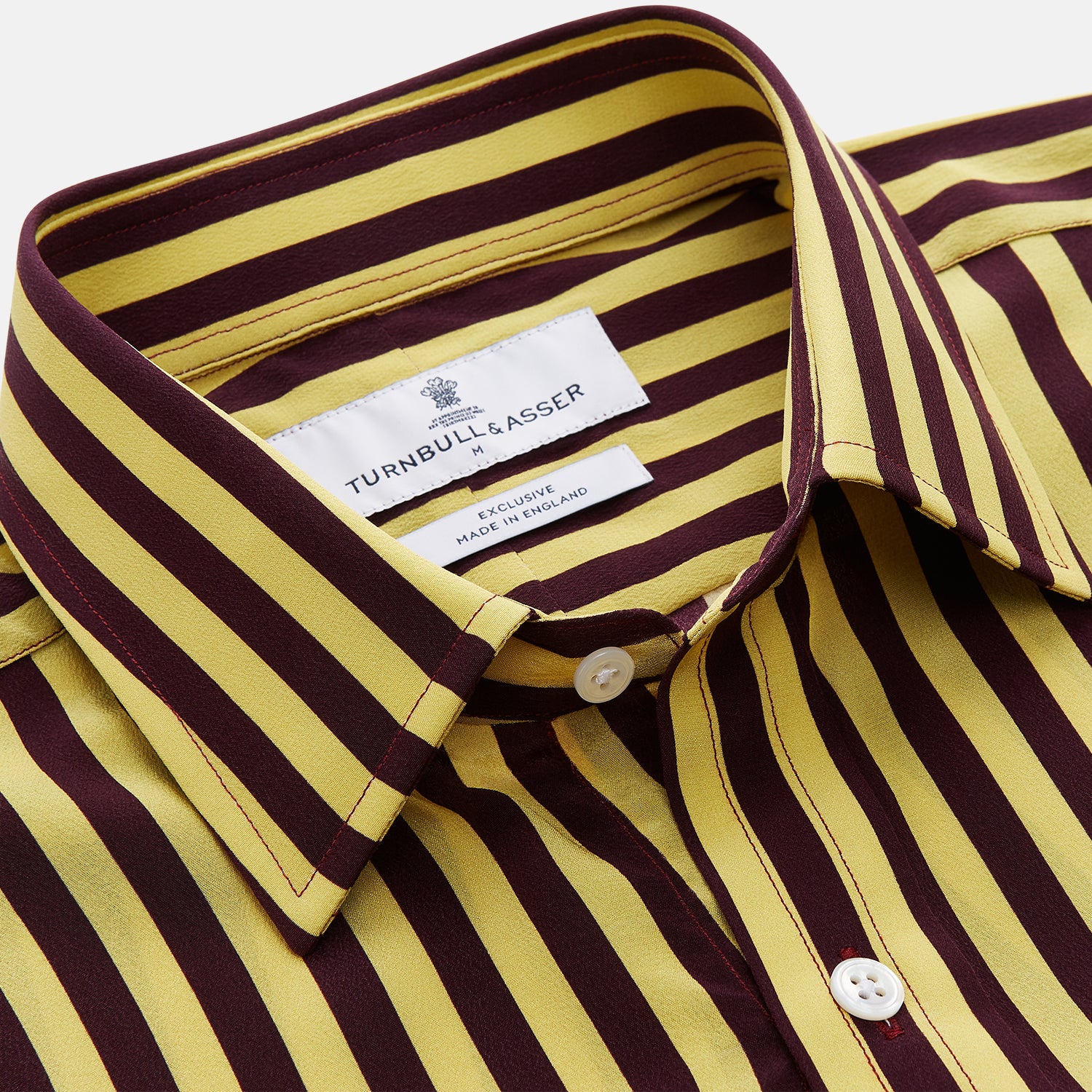 View 4 of product The Turnbull & Asser Yellow and Burgundy Candy Stripe Silk Weekend Fit Harold Shirt features long sleeves, a classic collar, white buttons, and a tailored design.