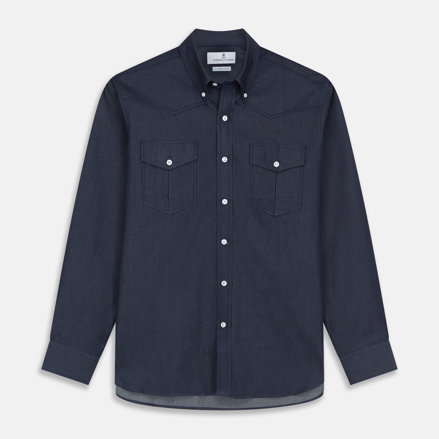 View 1 of product The Turnbull & Asser Navy Weekend Fit Larkin Shirt features a Dorset collar, long sleeves with 3-button cuffs, two chest pockets, and white snaps, shown laid flat against a white background.