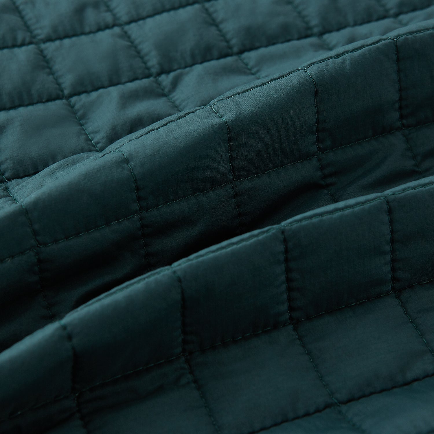 View 4 of product The Turnbull & Asser Forest Green Double-Breasted Quilted Gilet features black buttons, a chest pocket, two zippered side pockets, and an overlapping collar—ideal for layered dressing against a plain white background.