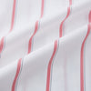 View 6 of product The Turnbull & Asser Coral Track Stripe Mayfair Shirt features a white Italian cotton fabric with vertical red stripes and a pointed T&A collar, shown against a plain light background.