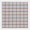 View 1 of product The Turnbull & Asser Hand Rolled Brown Overlay Check Handkerchief is a rectangular white cotton accessory with evenly spaced brown and black grid lines, forming squares—a timeless classic for gentlemen.