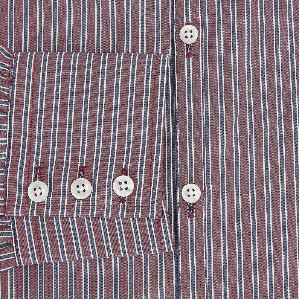 The Turnbull & Asser Wine Ticking Stripe Westminster Shirt features red, blue, and white vertical pinstripes on white and is shown laid flat on a white surface.