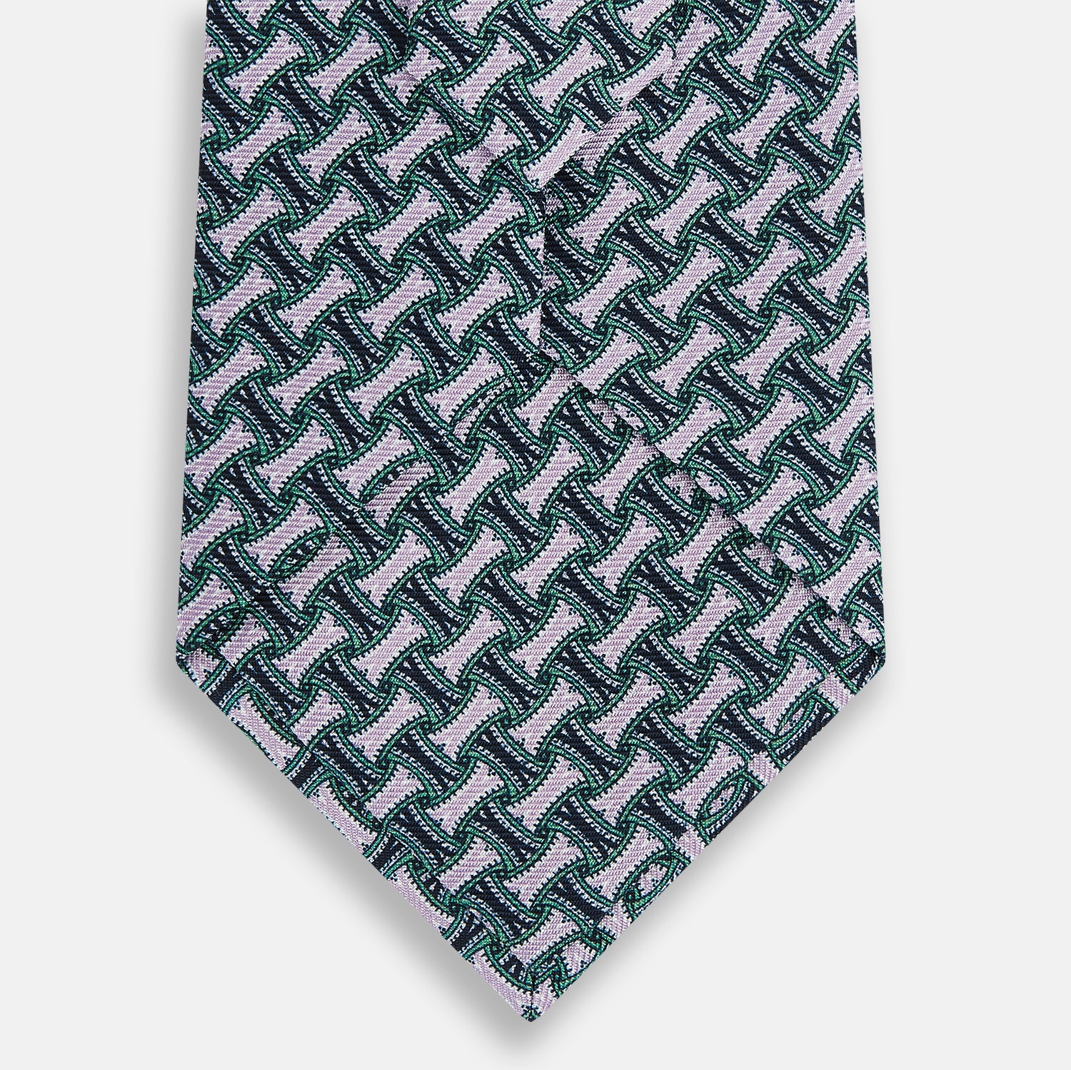 View 3 of product The Turnbull & Asser Lilac and Kelly Weave Patterned Silk Tie, rolled up, showcases a geometric design in lilac and green tones against a plain white background.
