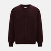 View 1 of product The Turnbull & Asser Burgundy Fine Merino V-Neck Cardigan features long sleeves and a button-down front, highlighting elegant handcrafted knitwear against a plain white background.