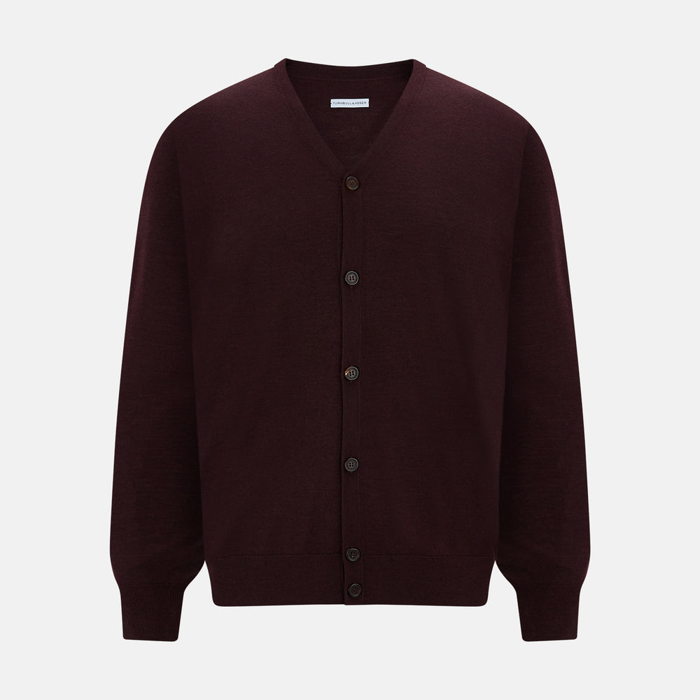 The Turnbull & Asser Burgundy Fine Merino V-Neck Cardigan features long sleeves and a button-down front, highlighting elegant handcrafted knitwear against a plain white background.