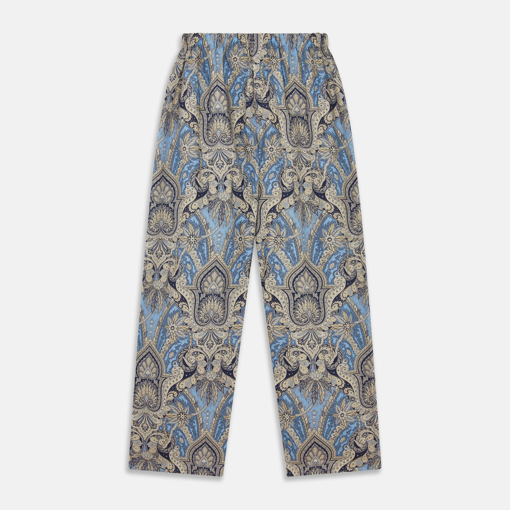The Turnbull & Asser Pale Blue Baroque Silk-blend Hyde Pyjama Set features a long-sleeve button-up shirt and pants in a blue and beige paisley pattern, shown flat on a white background.