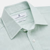View 2 of product The Turnbull & Asser Light Green Chambray Regular Fit Mayfair Shirt for men features long sleeves, a collar, white buttons, and buttoned cuffs, displayed flat on a white background.