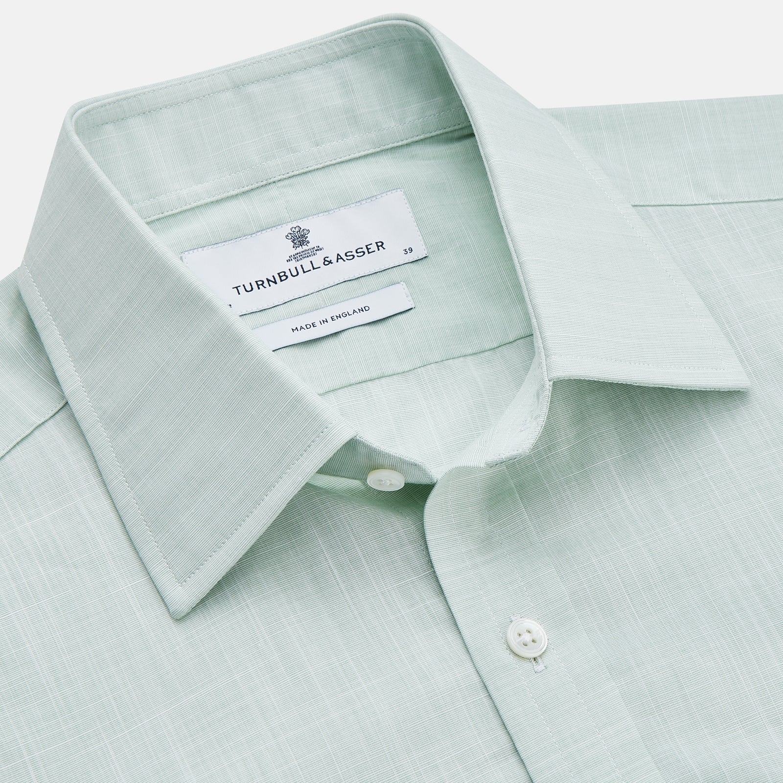 View 2 of product The Turnbull & Asser Light Green Chambray Regular Fit Mayfair Shirt for men features long sleeves, a collar, white buttons, and buttoned cuffs, displayed flat on a white background.