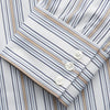 View 3 of product The Turnbull & Asser Sand Multi Stripe Regular Fit Shirt features a T&A collar, 3 button cuffs, and vertical blue, white, and light brown stripes. The shirt is shown neatly laid flat on a white background.