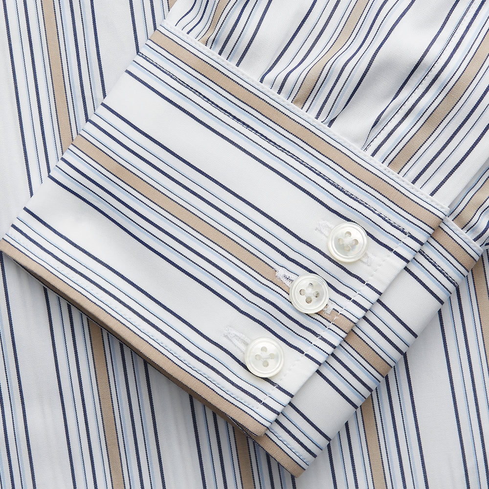 The Turnbull & Asser Sand Multi Stripe Regular Fit Shirt features a T&A collar, 3 button cuffs, and vertical blue, white, and light brown stripes. The shirt is shown neatly laid flat on a white background.