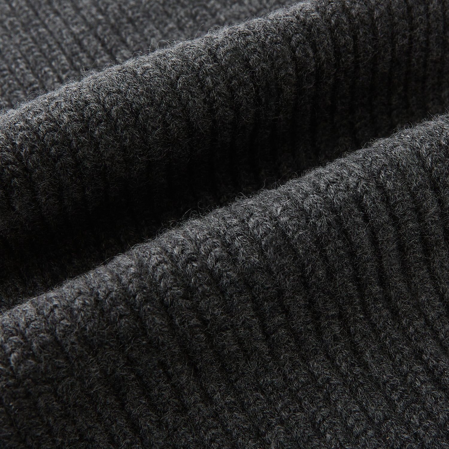 View 3 of product The Turnbull & Asser Graphite Rib-Knit Cashmere Scarf, a luxury winter accessory, is shown neatly looped against a plain white background.
