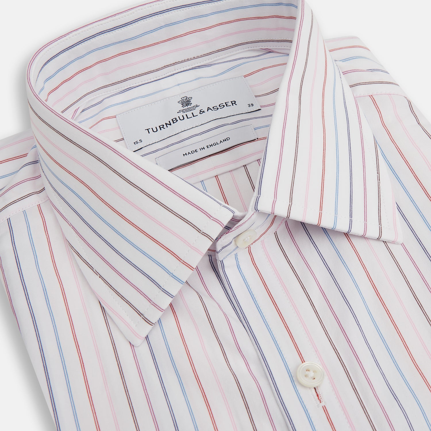 View 2 of product The Pink and Blue Multi Double Pinstripe Mayfair Shirt by Turnbull & Asser is a long-sleeve, button-up with a T&A collar, buttoned cuffs, and thin blue, red, and white stripes on a light background for a classic, formal look.