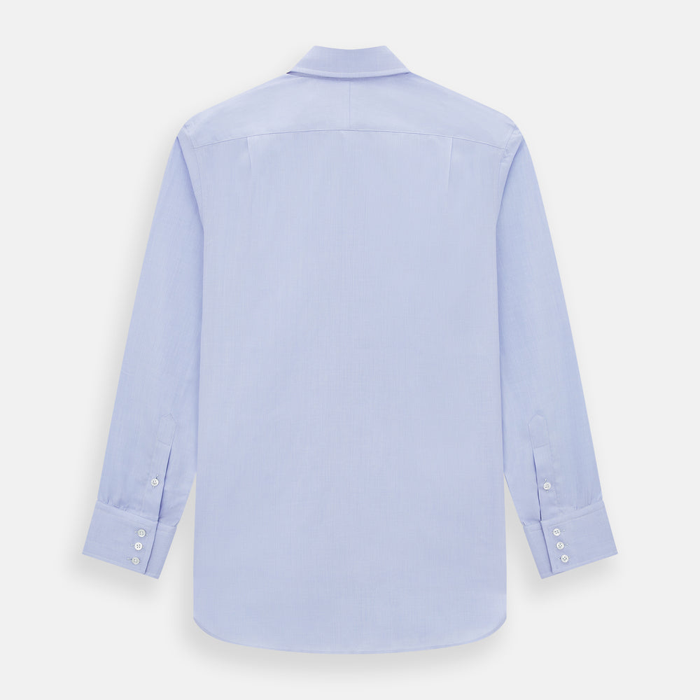The Turnbull & Asser BLUE HERRINGBONE TAILORED FIT SHIRT WITH KENT COLLAR features long sleeves and buttoned cuffs, offering a timeless formal look in a classic light blue herringbone fabric, laid flat on a white background.