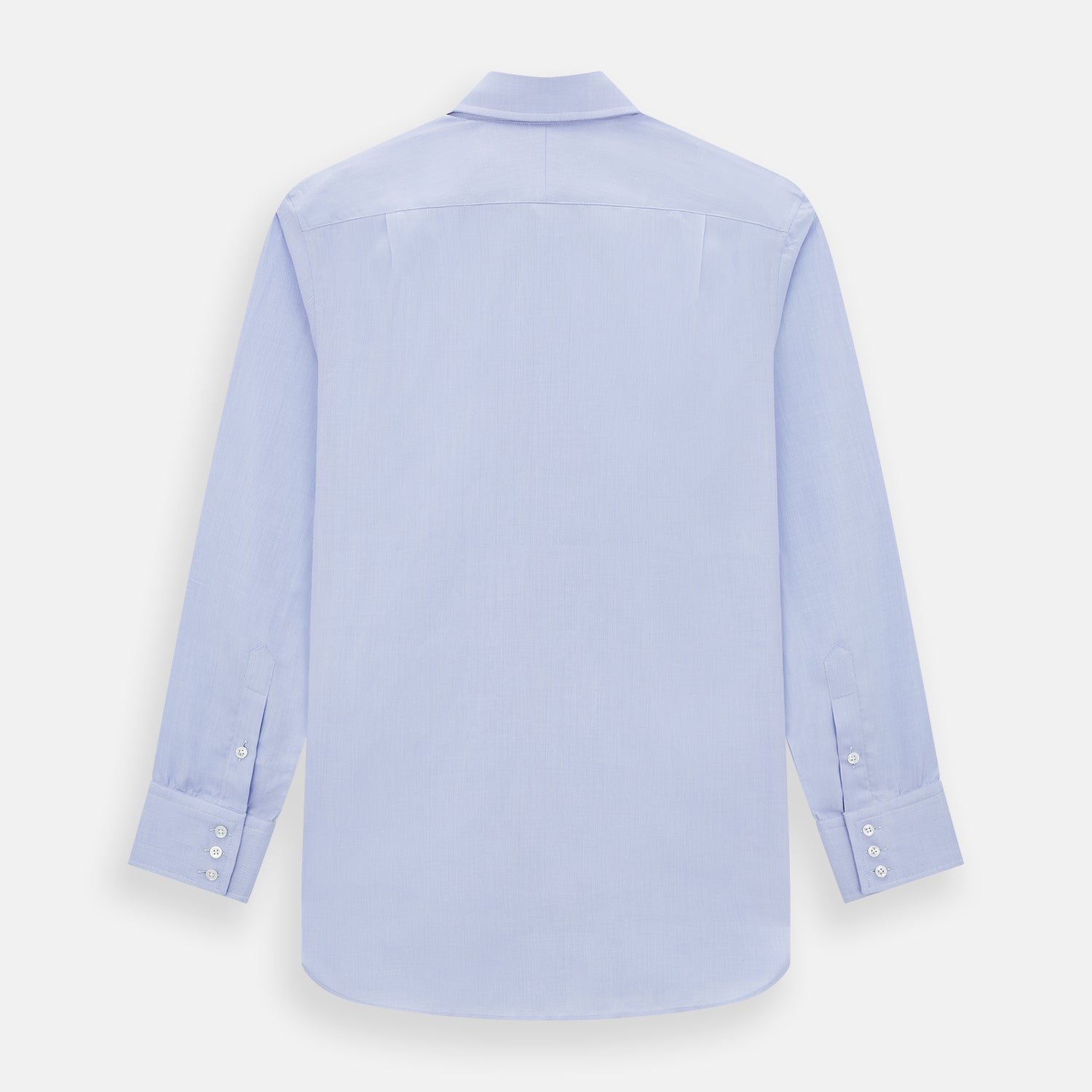 View 3 of product The Turnbull & Asser BLUE HERRINGBONE TAILORED FIT SHIRT WITH KENT COLLAR features long sleeves and buttoned cuffs, offering a timeless formal look in a classic light blue herringbone fabric, laid flat on a white background.