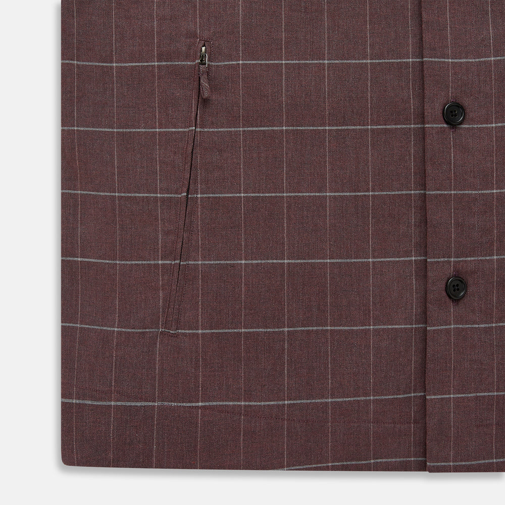 The Turnbull & Asser Burgundy Check Hampstead Overshirt, featuring a button-up front, collar, white windowpane pattern, and two front pockets, is laid flat on a white background—perfect for elegant formal wear.