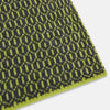 View 2 of product The Turnbull & Asser Graphite and Chartreuse Lemon Hexagon Cashmere Knitted Scarf features a geometric pattern in green and yellow tones, neatly folded to show both ends—an essential accessory with luxurious softness.