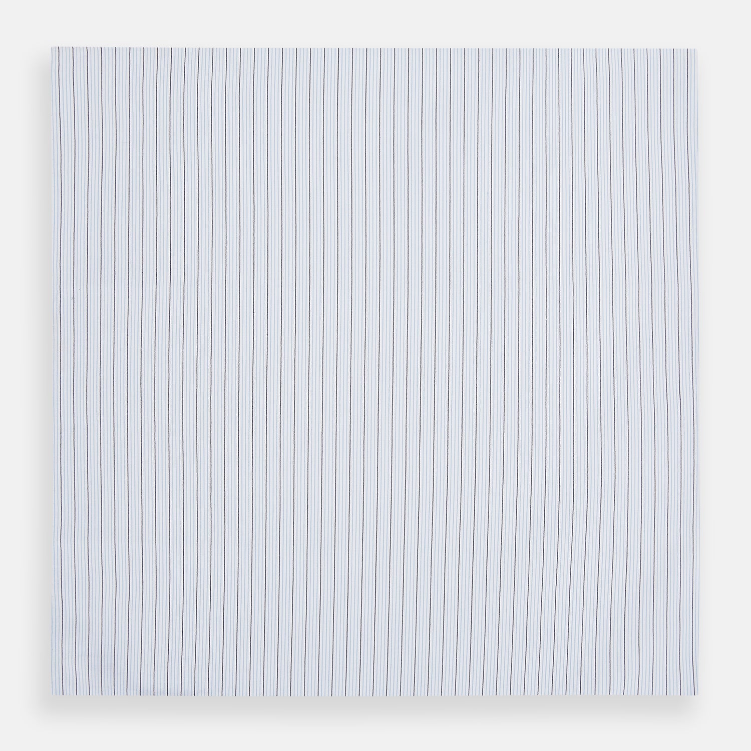 View 3 of product The Turnbull & Asser Hand Rolled Blue Multi Stripe Handkerchief features light blue cotton with thin black and white stripes, making it a refined accessory for the gentleman.